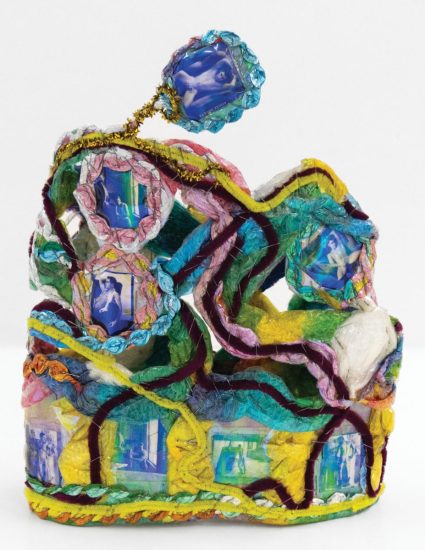 A colorful sculpture with pipe cleaners and photographs.
