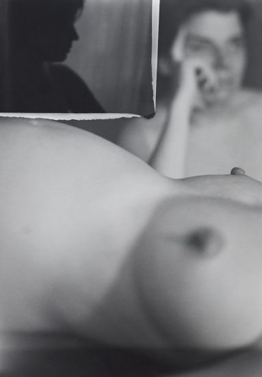 A black and white image of a nude figure.