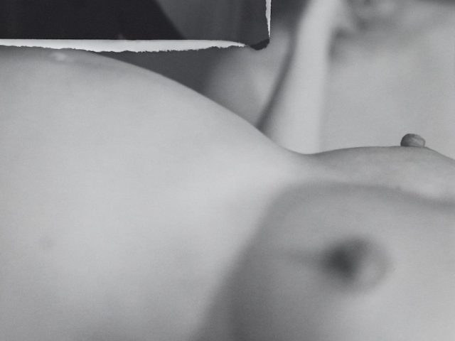 A black and white image of a nude figure.