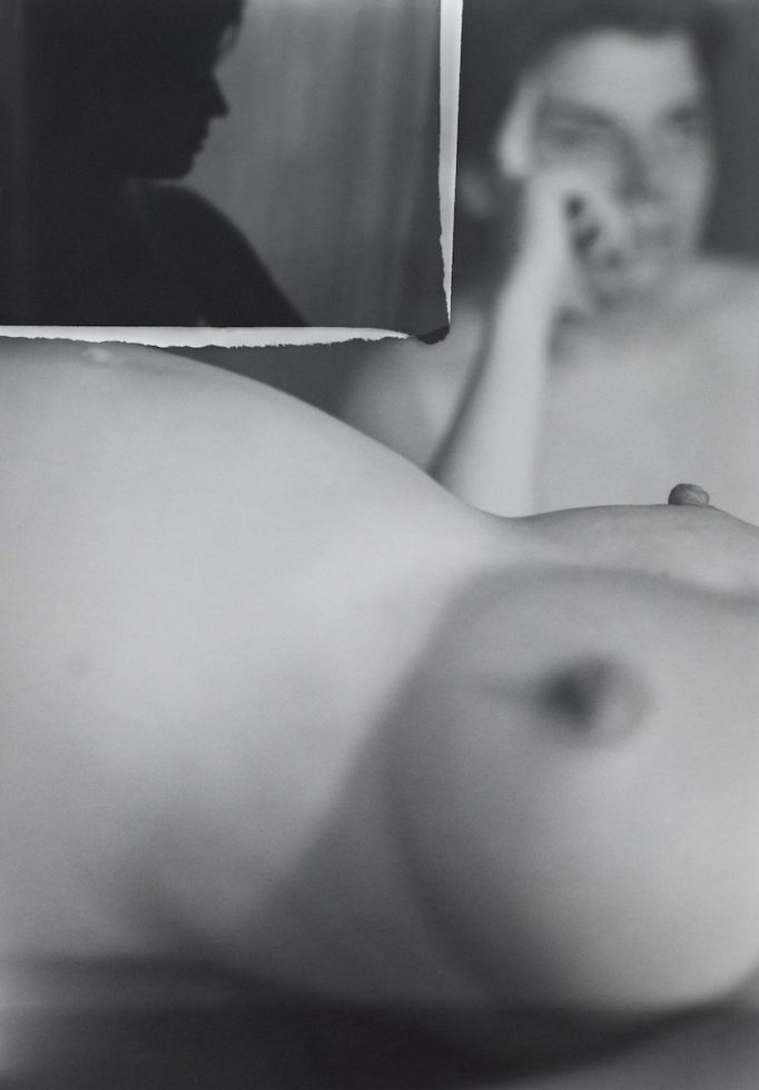 A black and white image of a nude figure.