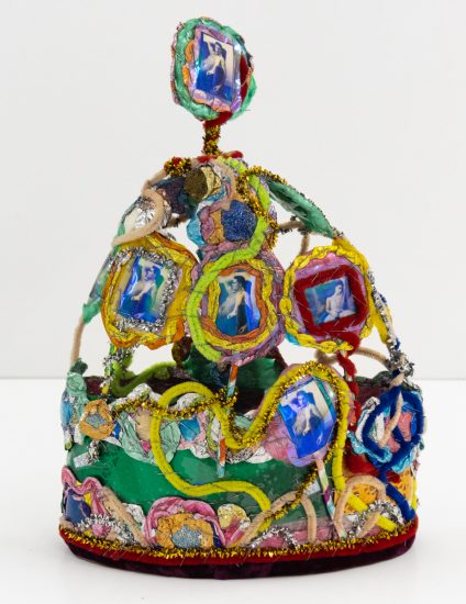 A brightly colored sculpture depicting a crown.