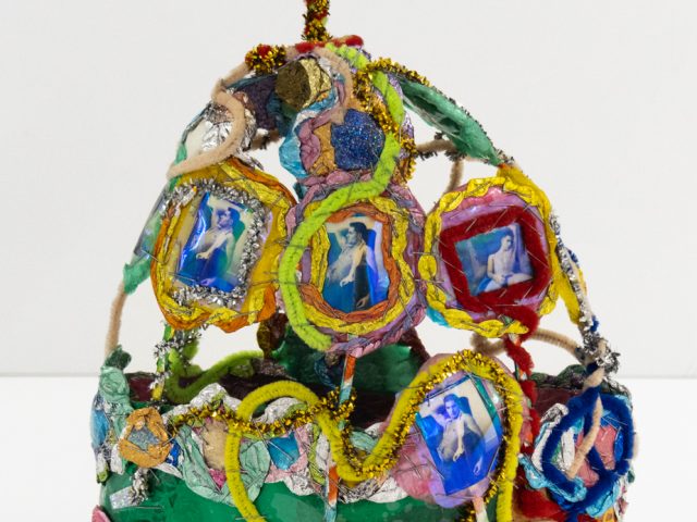 A brightly colored sculpture depicting a crown.