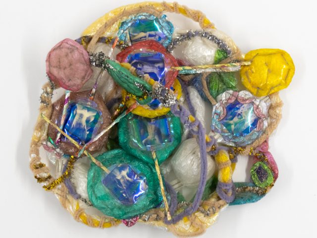 A brightly colored sculpture depicting a candy dish.