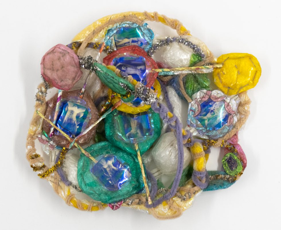 A brightly colored sculpture depicting a candy dish.