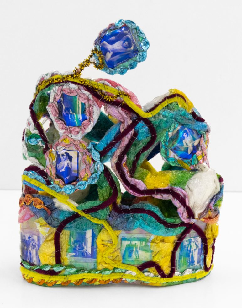 A brightly colored sculpture depicting a crown.