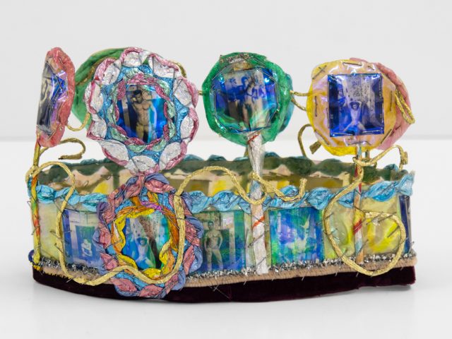 A brightly colored sculpture depicting a crown.