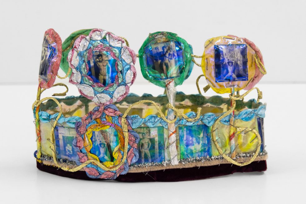 A brightly colored sculpture depicting a crown.