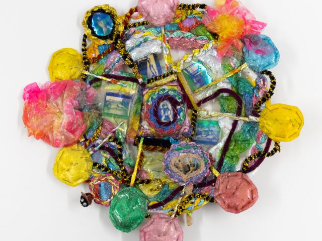 A brightly colored sculpture depicting a candy dish.