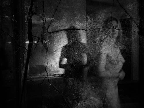 A black and white photograph of a nude woman.