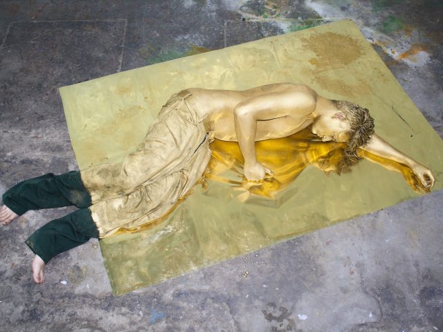 A color photograph of a man lying on mylar.