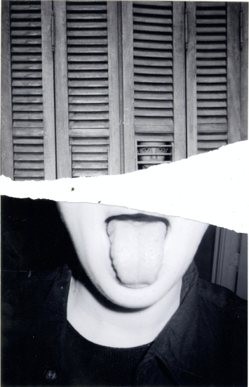 A black and white photograph of a girl sticking out her tongue.