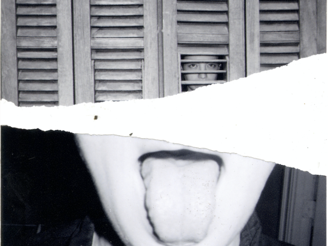 A black and white photograph of a girl sticking out her tongue.