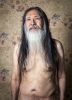 A color portrait of an older man wearing no shirt.