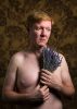 A color portrait of a person holding lavender flowers.