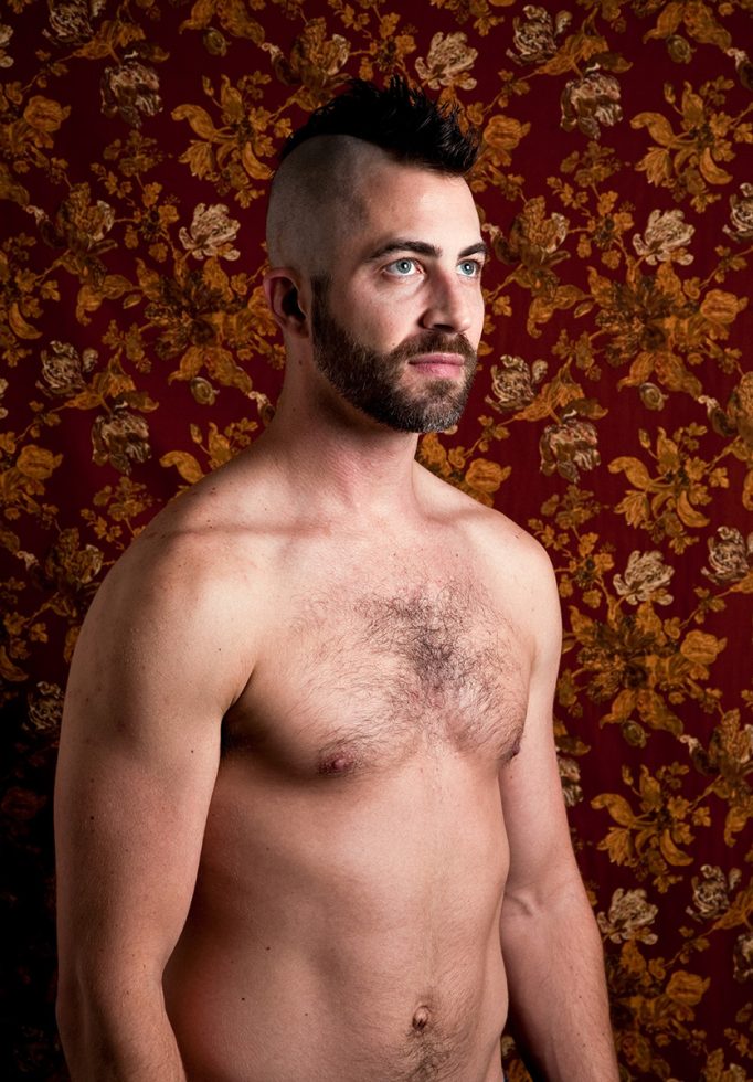 A color photograph of a shirtless man.