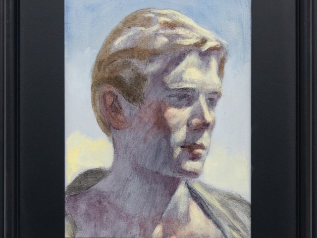 A picture of a painting of a young man looking to the side displayed in a black frame.