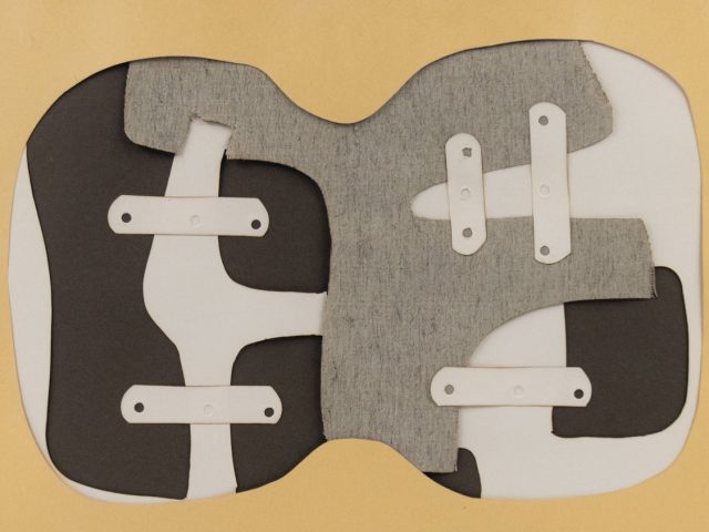 A collage of paper and fabric in gray, brown, and tan.