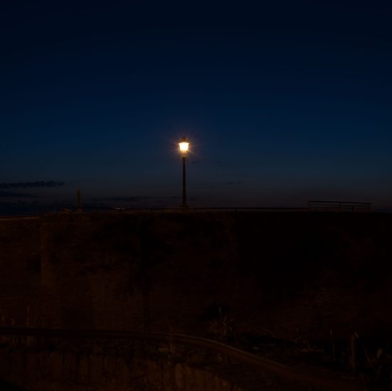This is a photograph of a lamp post at night.