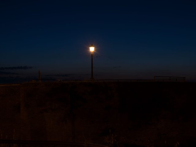 This is a photograph of a lamp post at night.