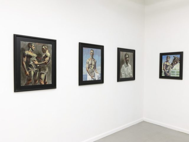 This image shows the walls of a gallery with four paintings of young man hanging in black frames.