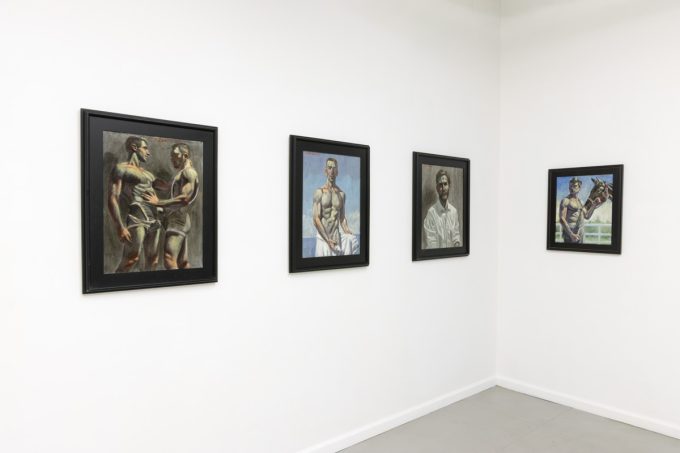 This image shows the walls of a gallery with four paintings of young man hanging in black frames.