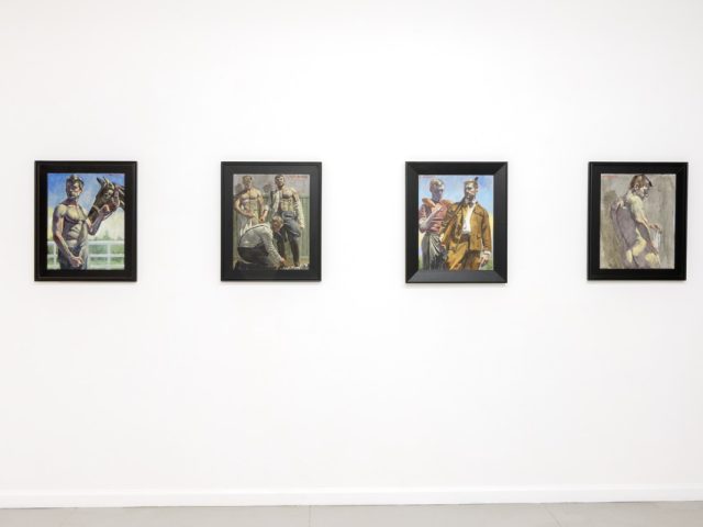 This photo depicts four paintings hung on a gallery wall. They depict young men.