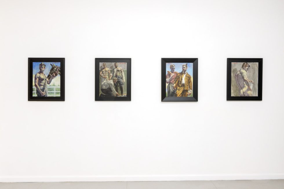 This photo depicts four paintings hung on a gallery wall. They depict young men.