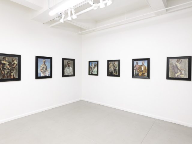 This photograph shows the walls of a gallery where eight paintings hang. They depict young men performing various activities.