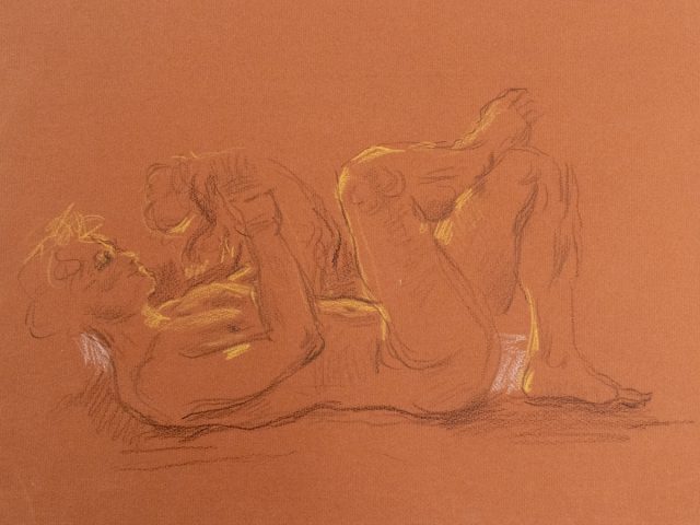 This is a sketch on orange paper of a man laying on his back and holding an animal up to his face.