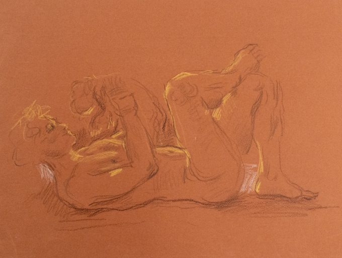 This is a sketch on orange paper of a man laying on his back and holding an animal up to his face.