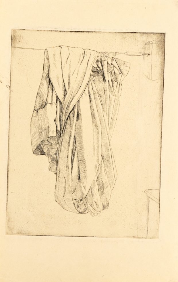 In this etching, a jumble of fabric hangs from a line.