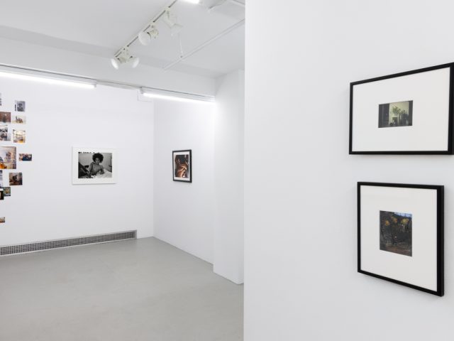 This photograph shows the walls of a gallery space. Lindsay Perryman's photographs are hung, along with their collage.
