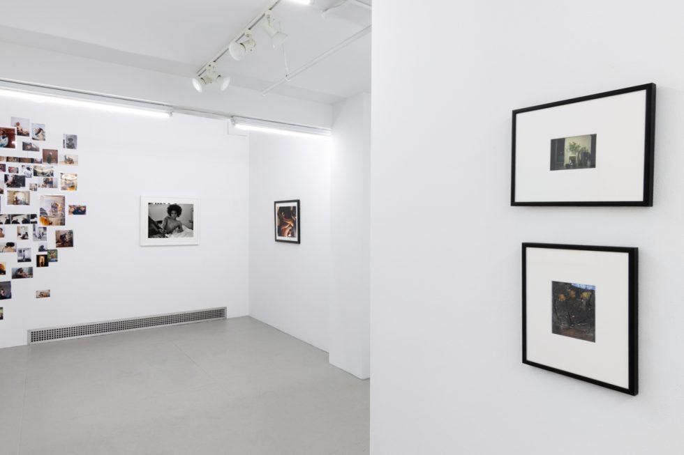 This photograph shows the walls of a gallery space. Lindsay Perryman's photographs are hung, along with their collage.