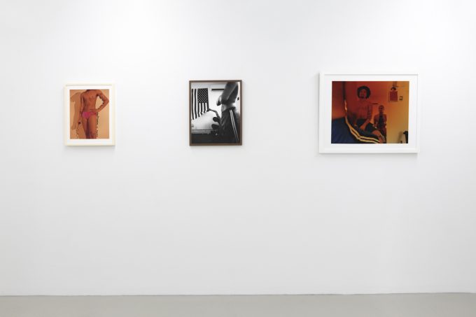 This image shows the walls of a gallery, where three images by Lindsay Perryman are hanging.