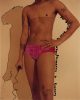 In this color photograph, a person wearing pink underwear is seen from the knees up to their neck.