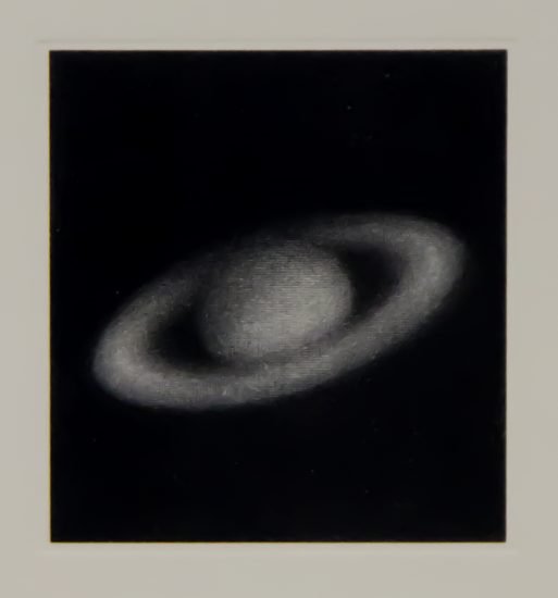 This is a lithograph of Saturn in black & white on woven paper.