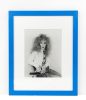 This photograph shows a man wearing a frizzy wig while sitting in a chair.