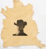 This is a photograph of a man in a cowboy hat, seen from the neck up, printed on an animal hide.