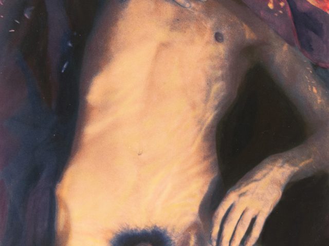 This photograph shows the naked torso of a man with his head shrouded in red fabric.
