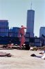 This color photograph shows a man posing in front of a Manhattan skyline.