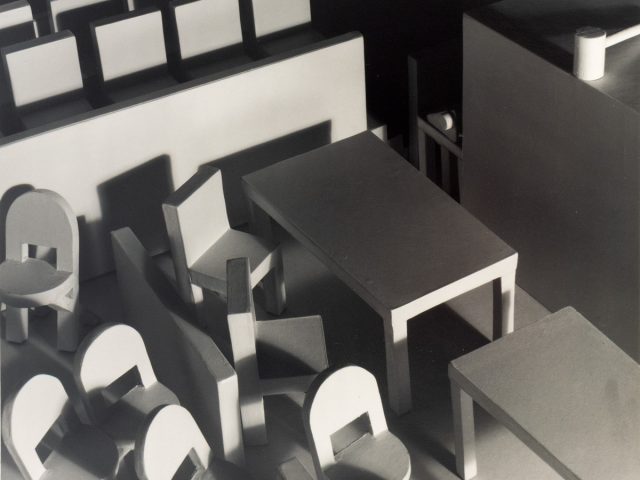 This black and white photograph shows a courtroom filled with furniture, seen from above.