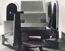 This black and white photograph shows a large typewriter sitting in an open room.