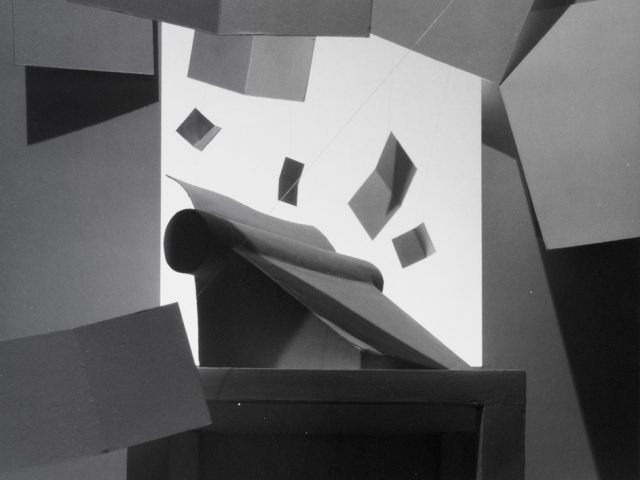 This black and white photograph shows a typewriter with papers flying put of the top.