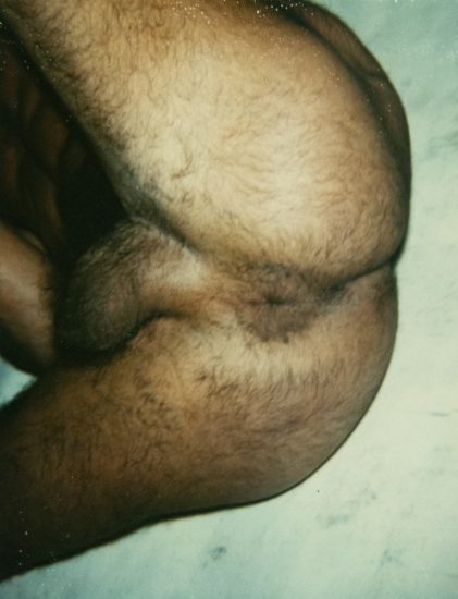 A color photograph of a man's hairy bum.