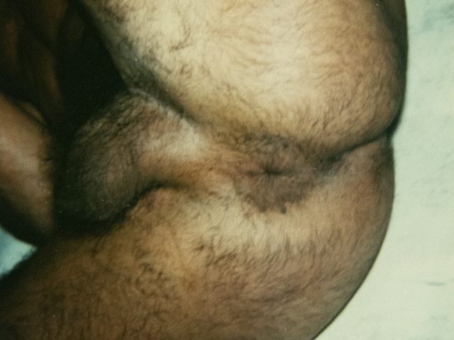 A color photograph of a man's hairy bum.