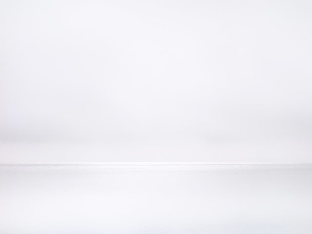 This photograph shows grey water meeting grey horizon on an ocean.