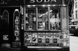 This black and white photograph shows the exterior of a shop.