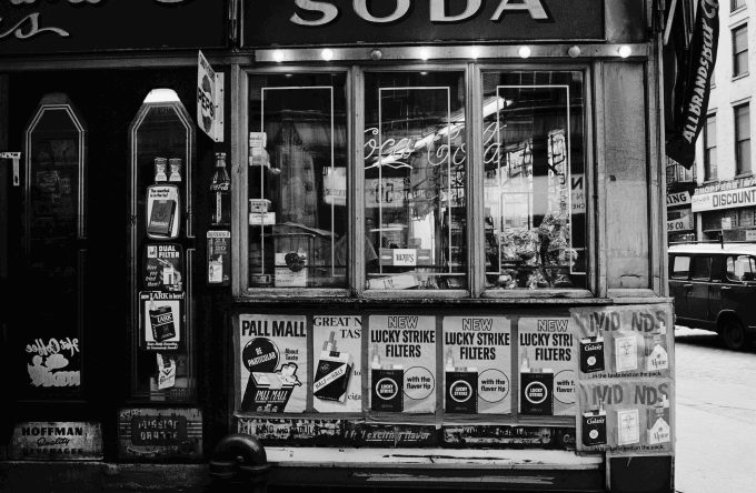 This black and white photograph shows the exterior of a shop.